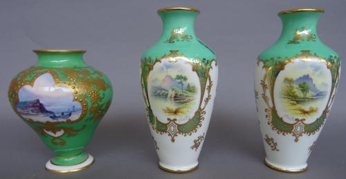 A pair of small Coalport slender ovoid vases, early 20th century, painted by P.Simpson, signed, with named views, `Buttermere' and `Derwent water', pr