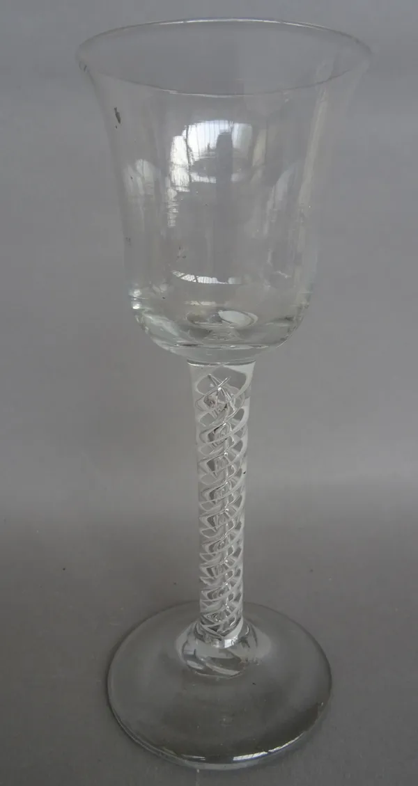 A mixed twist wine glass, circa 1765, the waisted ogee bowl with an air spiral cable alternating with an opaque spiral cable, plain foot, 15cm. high.