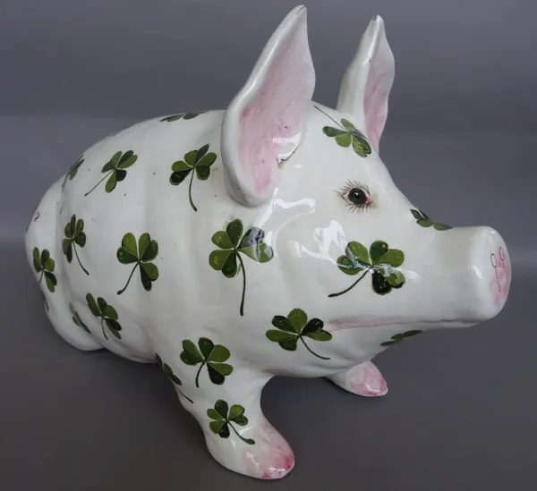 A large Wemyss ware pottery pig, Bovey Tracey period, post 1930, seated on its haunches and painted with scattered shamrock,  green painted mark, 'Wem