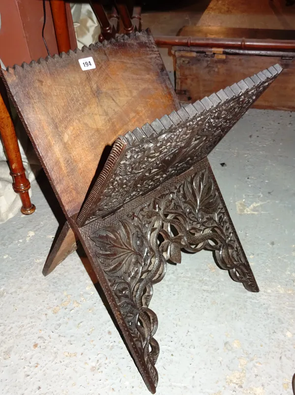 A profusely carved hardwood folio stand carved with serpents, 30cm wide.  H6