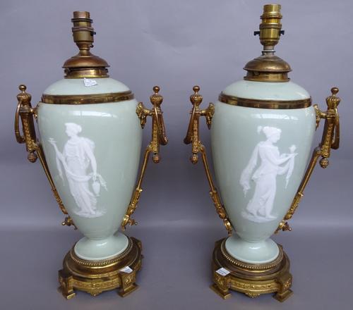 A pair of French pate- sur- pate ormolu mounted oil lamps bases (converted), late 19th century, possibly decorated by Fernand Paillet depicting Grecia