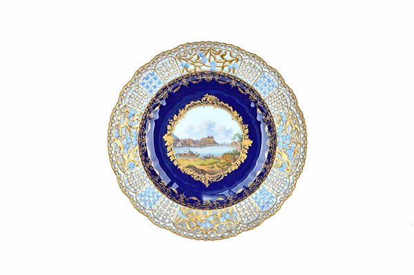 A good Meissen porcelain cabinet plate, second half 19th century, painted with a titled view, Meissen, inside a gilt frame against a cobalt blue groun