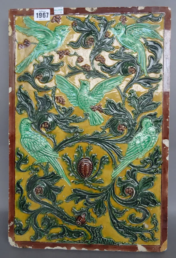 A Chinese style majolica pottery tile, 20th century, relief decorated with birds amongst foliage, 47cm x 31cm.