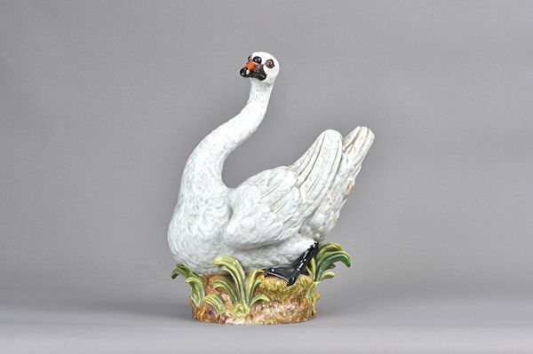 A large Meissen  figure of a swan, late 19th century, nestled on a naturalistic base, blue crossed sword mark, incised and impressed marks, 31cm high.