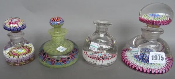 A Whitefriars glass inkwell and stopper with millefiori cane inclusions (13cm high), three similar smaller glass ink wells with millefiori cane inclus