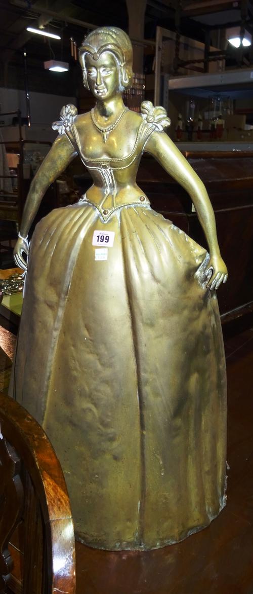 An early 20th century brass figural fireguard formed as a woman in Victorian dress, 45cm wide  x 80cm high.  BAY 1