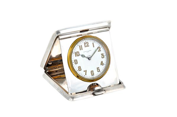 A Mappin & Webb silver rectangular cased, keyless wind travelling clock, the circular enamelled dial with Arabic numerals and detailed Mappin & Webb,