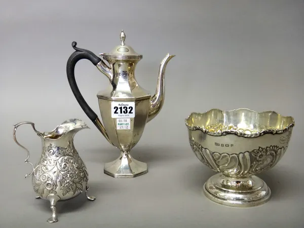 Silver, comprising; an octagonal baluster shaped small coffee pot, with a black composition handle, London 1903, a bowl, with floral and scroll emboss