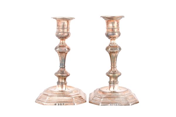 A pair of Victorian Britannia Standard silver table candlesticks, each with a knopped stem, raised on a cut cornered square base, in the 18th century