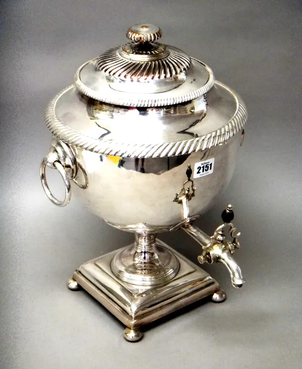 A Victorian plated on copper twin handled tea urn, with a detachable cover, having partly fluted decoration, further decorated with gadrooned rims, fi