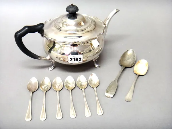 Silver, comprising; a teapot of circular form, raised on three feet, with black fittings, Sheffield 1915, a set of six coffee spoons, Birmingham 1920