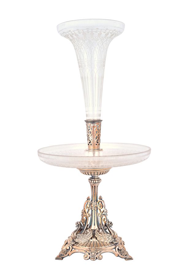 A Victorian silver plated and glass table centrepiece, the stand with three mythological winged animal supports, supporting an etched circular glass s