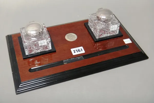 A silver mounted rectangular mahogany inkstand, the centre with a presentation plaque detailed 28 April 1993, fitted with two silver hinge lidded face