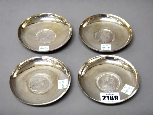 Four circular dishes, each mounted with a re-struck Maria Theresia dollar, (one of the dishes presentation inscribed), (4).