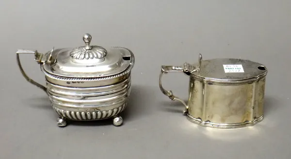 A Victorian silver mustard pot, of curved rectangular form, with partly fluted decoration, raised on spherical feet, Chester 1899, with a blue glass l