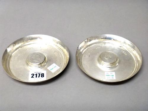 Two silver circular dishes, one mounted to the centre, with a George III half crown 1819 and the other mounted to the centre with a George IV half cro
