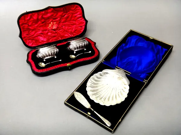 A pair of late Victorian silver salts, each of curved rectangular form, with partly fluted decoration and raised on four spherical feet, Birmingham 18