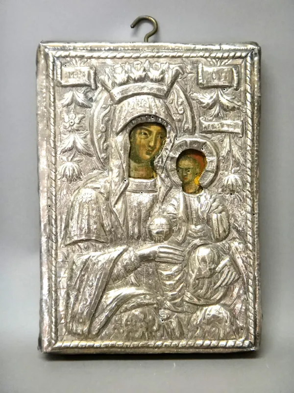 A painted wooden icon depicting The Virgin and Child, probably Greek, 19th century, the Turkish silver coloured metal oklad with embossed and engraved