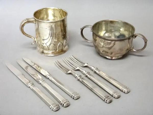 Silver, comprising; a twin handled sugar bowl, Chester 1902, three pairs of dessert or fruit knives and forks, Sheffield 1931 and a christening mug, d