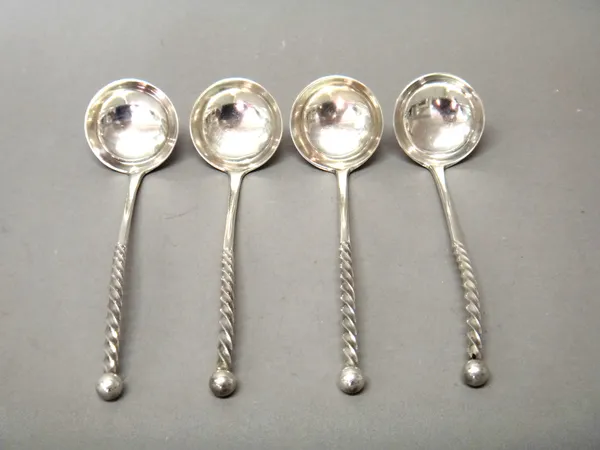 A set of four late Victorian Scottish silver toddy ladles, each stem with spiral decoration and with a bead finial, crest engraved, Glasgow 1892, comb