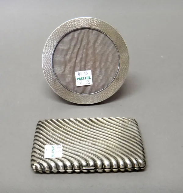 A silver cased rectangular wallet/aide memoire, with spiral banded decoration, the hallmark rubbed and a silver mounted oak circular photograph frame