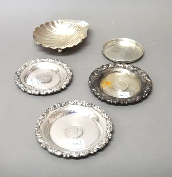 A silver butter shell raised on three spherical feet, Sheffield 1903, a silver part christening set, comprising; a napkin ring, a knife, a fork and a