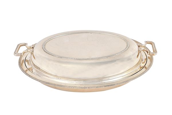 A silver twin handled oval lidded entree dish, having decorated rims, by Goldsmiths and Silversmiths Company Ltd, London 1931, weight 1255 gms. Illust