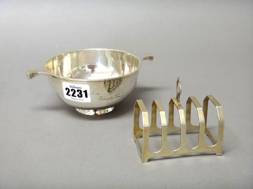 Silver and silver mounted wares, comprising; a twin handled presentation bowl of circular form by Walker & Hall, Sheffield 1926, a five bar toast rack