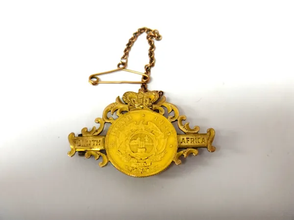 A South Africa half pond, 1895, mounted as a brooch, detailed South Africa and with a crown surmount, fitted with a safety chain.