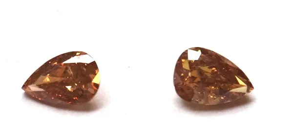 Two pear-cut loose diamonds, A: 0.51ct., fancy deep brown yellow, SI2, B: 0.67ct., fancy deep brownish yellow, I1, (2).This Lot is subject to VAT on t