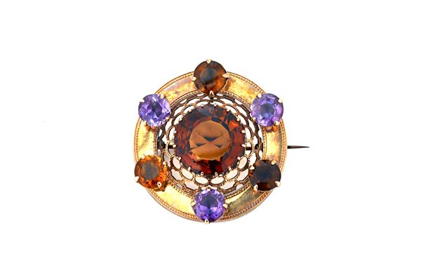 A Victorian Scottish gold, amethyst and vary coloured citrine set circular brooch, claw set with the principal circular cut citrine to the centre, wit