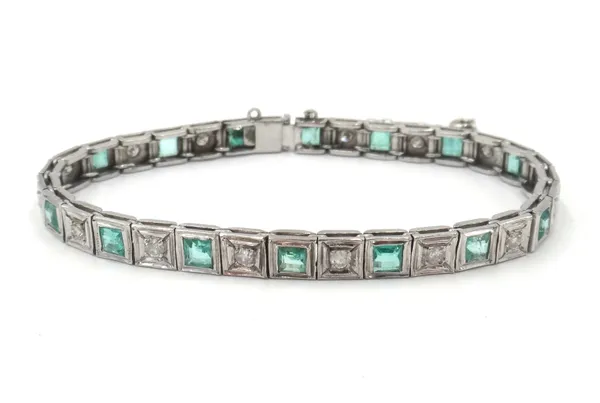 An emerald and diamond bracelet, mounted with a row of square cut emeralds, alternating with circular cut diamonds within square shaped sittings, on a