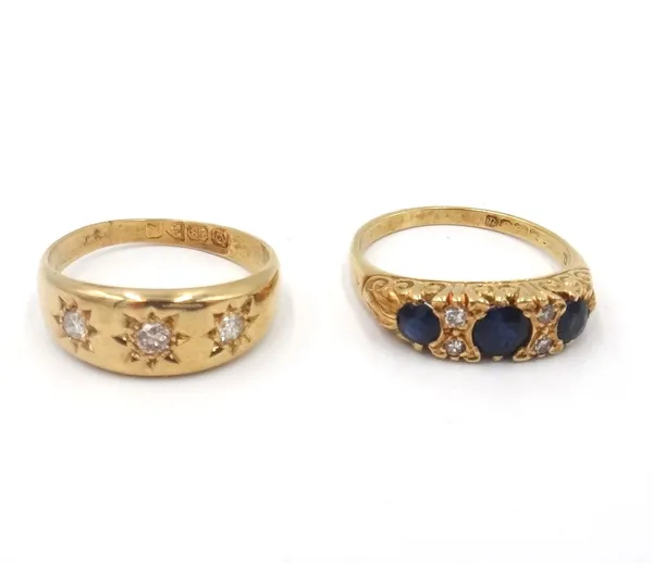 An 18ct gold and diamond three stone ring, star gypsy set with circular cut diamonds, Chester 1912, ring size N and an 18ct gold, sapphire and diamond