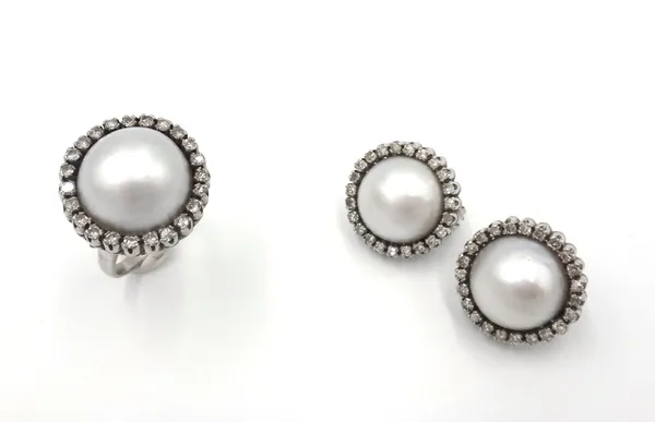 A mabe pearl and diamond ring, mounted with the mabe pearl in a surround of circular cut diamonds, ring size O and a pair of mabe pearl and diamond ea