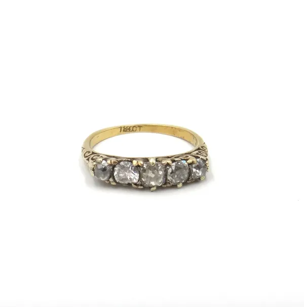 A gold and diamond five stone ring, mounted with a row of variously cut diamonds, the mount decorated with scroll pierced sides, detailed 18 CT, ring