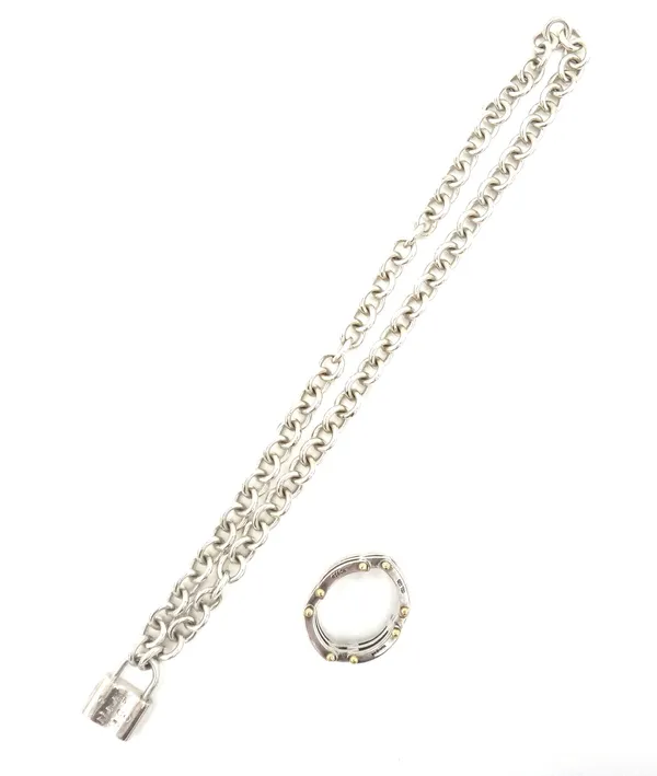 A Tiffany & Co gold and silver ring, in an articulated curved bar link design, detailed T & Co 925 750 and a Tiffany & Co silver neckchain, in an oval