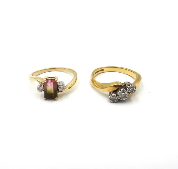 An 18ct gold and diamond three stone ring, mounted with circular cut diamonds, in a crossover design, ring size M and a half and a gold, vary coloured