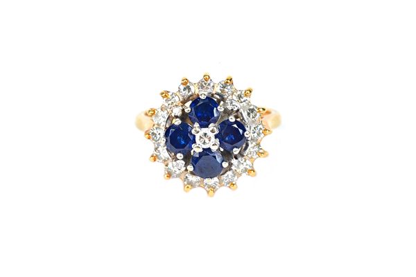 A gold, diamond and sapphire cluster ring, claw set with the principal circular cut diamond in a surround of four circular cut sapphires and with an o