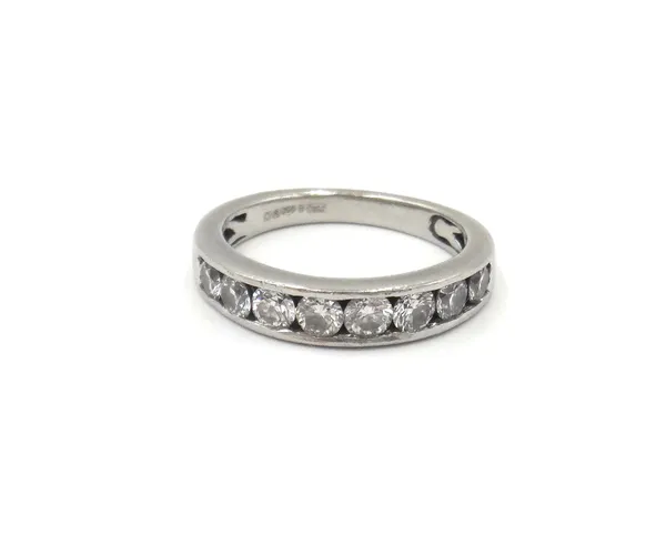 A platinum and diamond ring, mounted with a row of eight circular cut diamonds, ring size M 1/2.