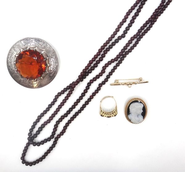 A silver mounted large orange paste set circular brooch, engraved with a border of thistles, a 9ct gold mounted banded agate oval pendant brooch, desi