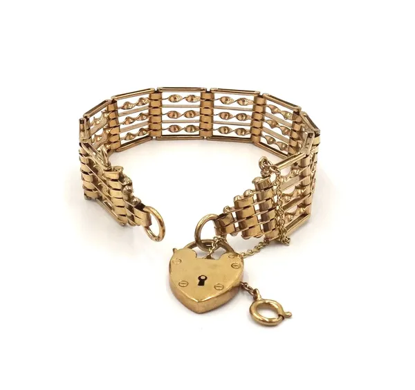A 9ct gold bar and twisted bar link gate bracelet, with a 9ct gold heart shaped padlock clasp, fitted with a safety chain, weight 19.3 gms.