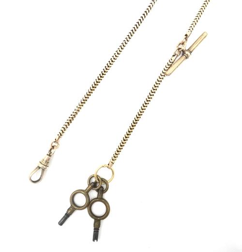 A gold Brazil link watch Albert chain, fitted with a T bar and with a swivel, apparently unmarked and two base metal watch keys, weight of chain appro