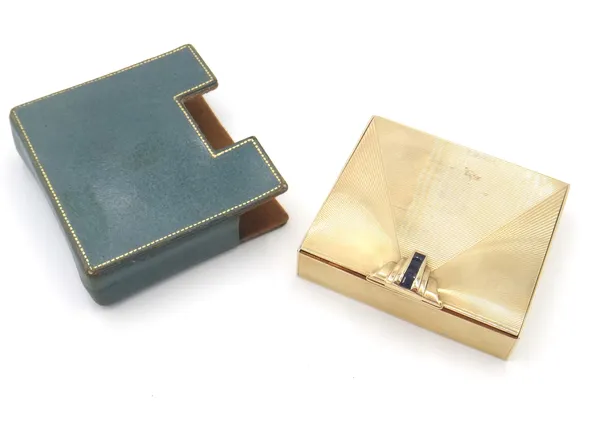 A Tiffany & Co gold and sapphire set lady's rectangular powder compact, fitted with a mirror within, the exterior with banded geometric decoration and