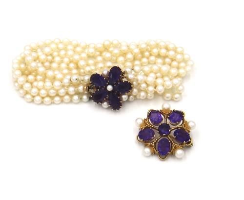 A 9ct gold, amethyst and cultured pearl brooch, claw set with a circular cut amethyst at the centre, in a surround of five larger oval cut amethysts,