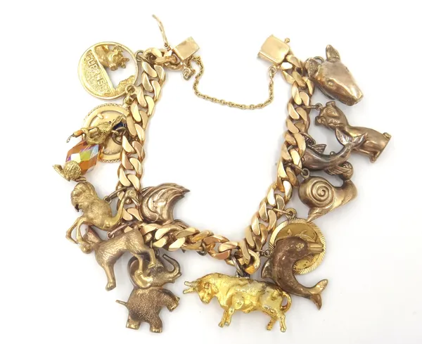 A gold faceted curb link charm bracelet, fitted with fourteen various gold and gilt metal charms, including a 9ct gold snail, a 9ct gold dolphin, a 9c