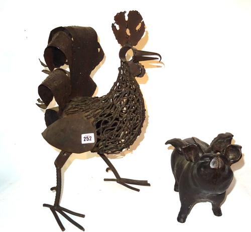 Metalware, including; a 20th century steel model of a chicken, 40cm high and a cast metal money box formed as a winged pig, (2).  S2B