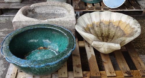 Garden statuary comprising 20th century reconstituted stone, including; a bird bath formed as a shell, 64cm wide x 20 cm high a trough 62cm wide x 20c