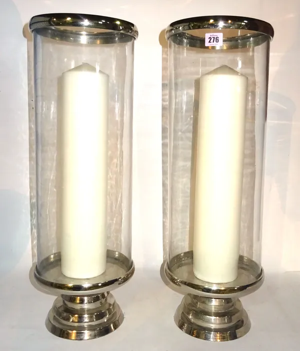 A pair of 20th century glass hurricane vases with chrome metal bases, 58cm high, (2).  BAY 3