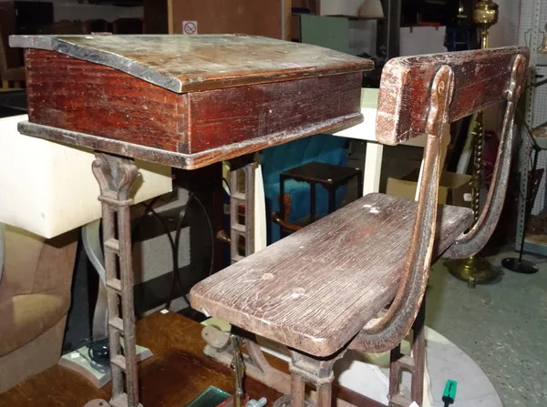 An early 20th century oak school desk with cast iron base, 56cm wide.  BAY 3