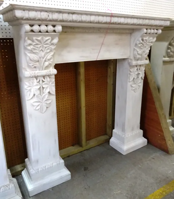 A 20th century white painted fire surround with floral and egg and dart decoration, 140cm wide x 139cm high, aperture 78cm wide x 104cm high. EXTRA